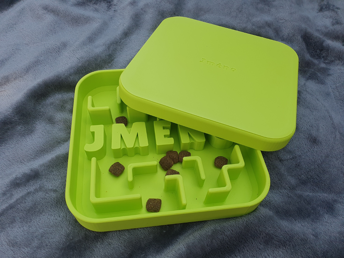 medium sized puzzle bowl with kibble partially covered by lid