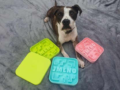 3 medium-sized puzzle bowls and one lid next to a dog laid on a blanket